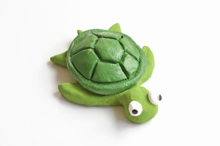 Clay turtle on a white background