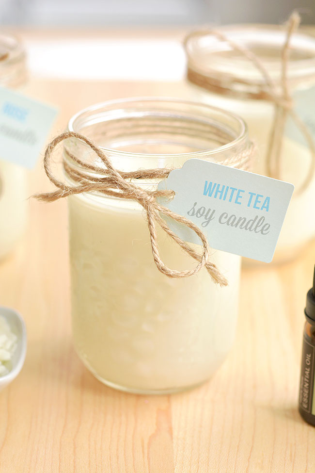Mason jar candles decorated with twine and a label