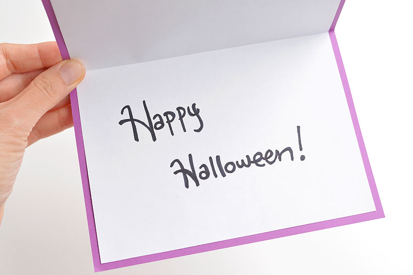 Happy Halloween written inside of a DIY string art Halloween card