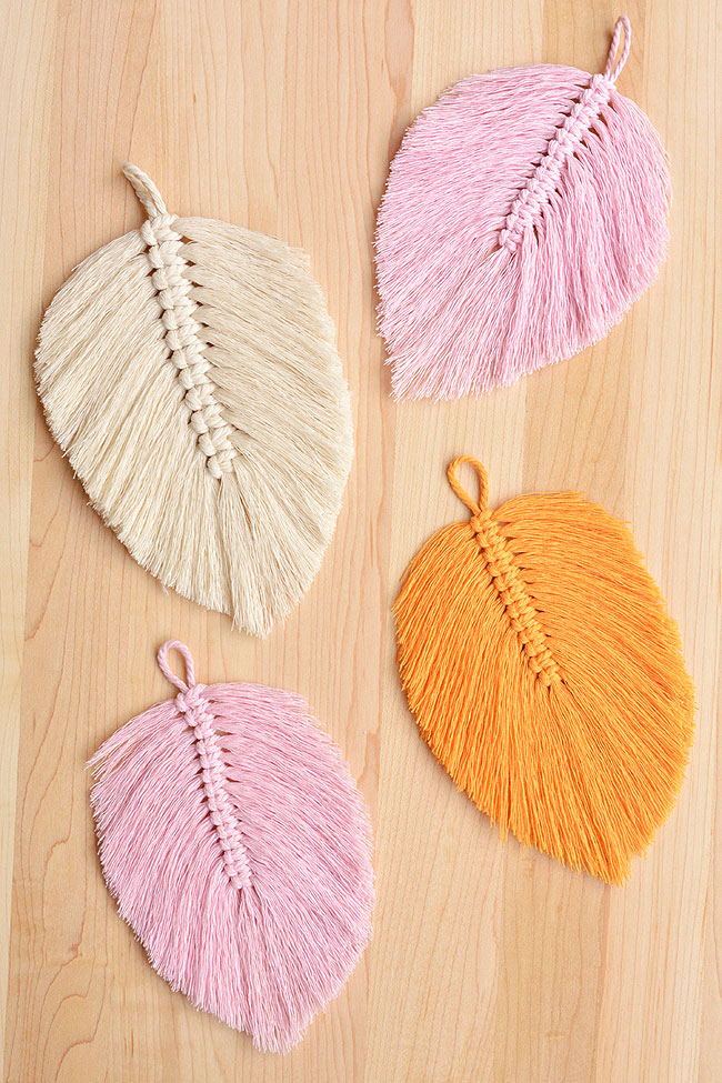 DIY macrame feathers on a wooden background