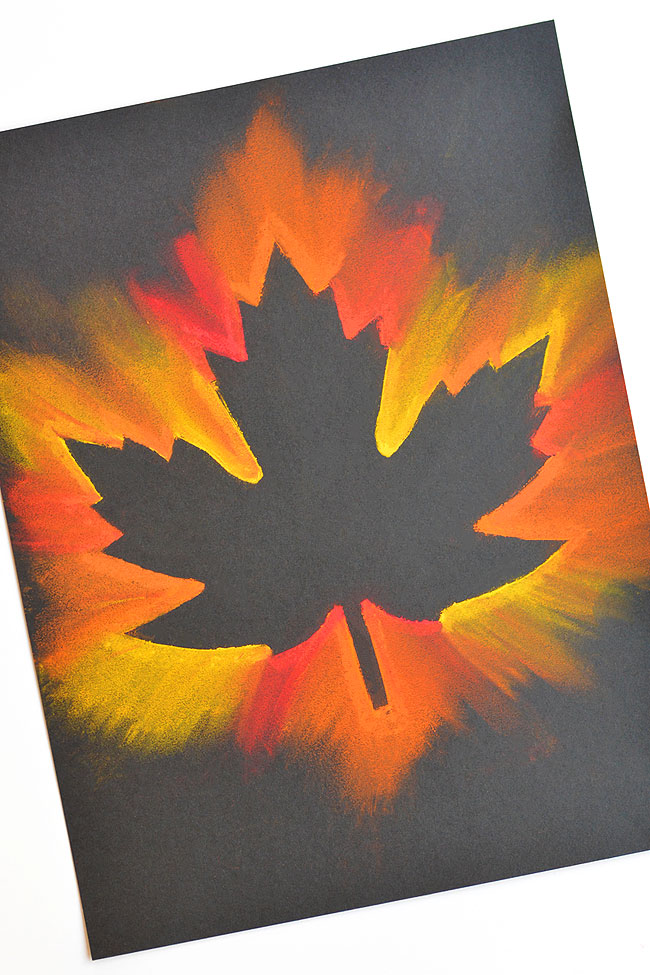 Maple leaf colored in red, orange, and yellow pastels