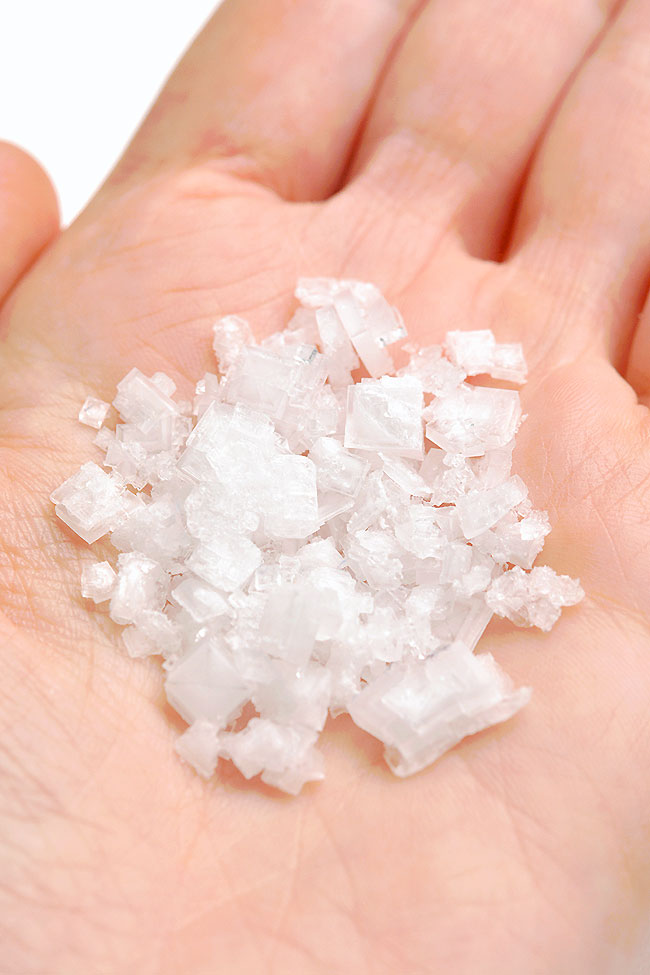 Sea salt crystals held in a palm