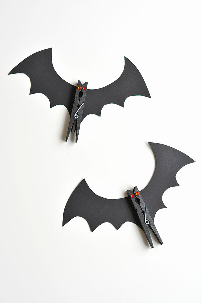 Two bat clothespins on a white background