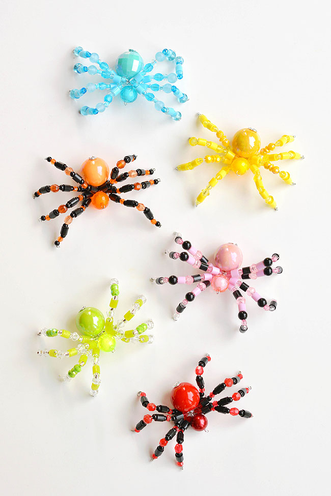 Colourful group of beaded spiders on a white background