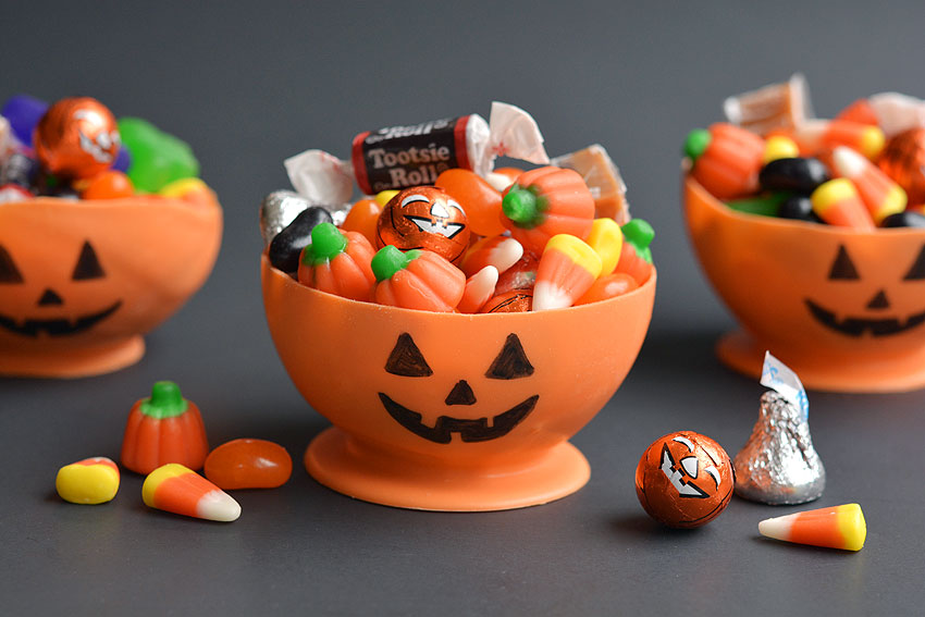 Orange bowl with jack-o-lantern face made of candy melts