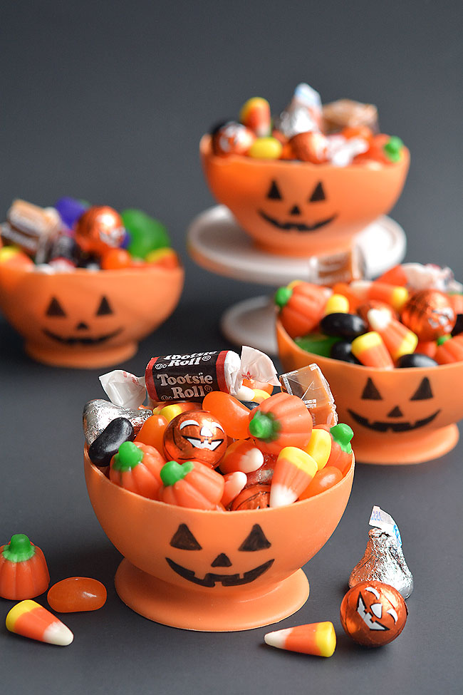 Candy melt pumpkin bowls full of Halloween candy