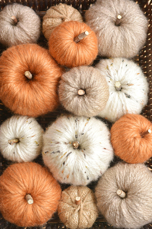 Chunky yarn pumpkin in a basket with many others