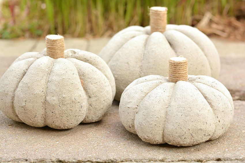 A group of three concrete pumpkins