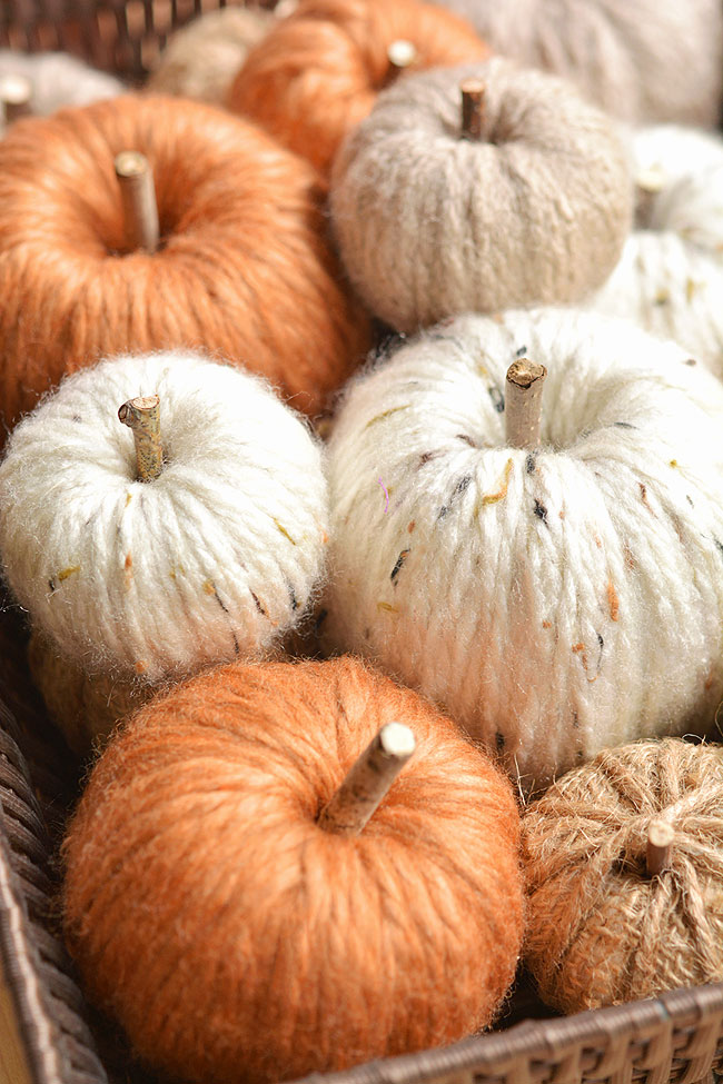 DIY yarn pumpkins in a brown basket