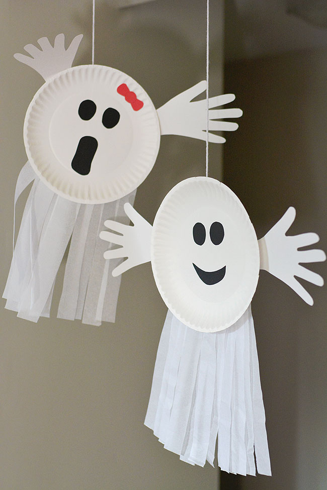 Paper plate ghosts hanging from the ceiling
