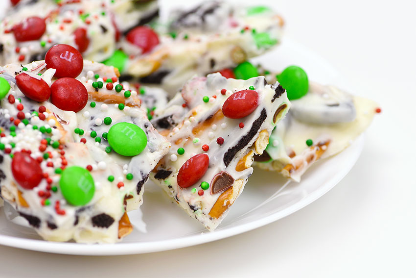 Closeup of Christmas candy cookie bark on a white plate