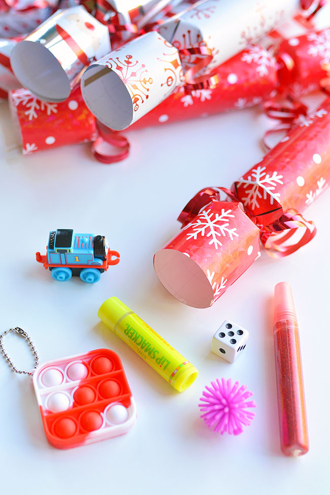 Christmas crackers alongside toys to put in them