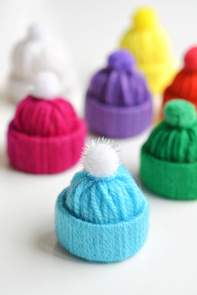 Yarn hat ornaments on a white background