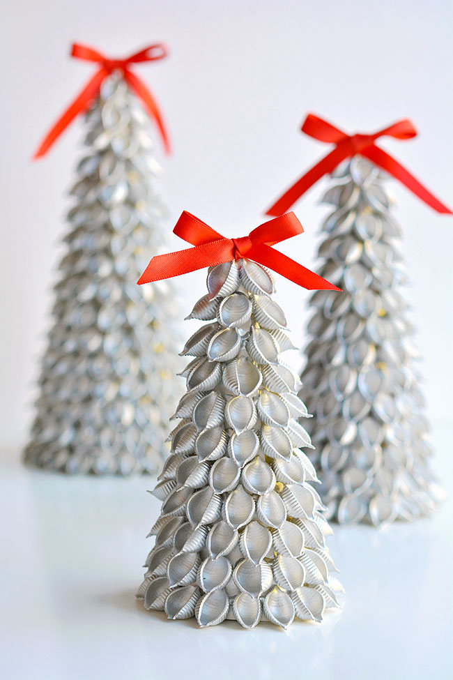 A grouping of three noodle Christmas trees with red bows on top