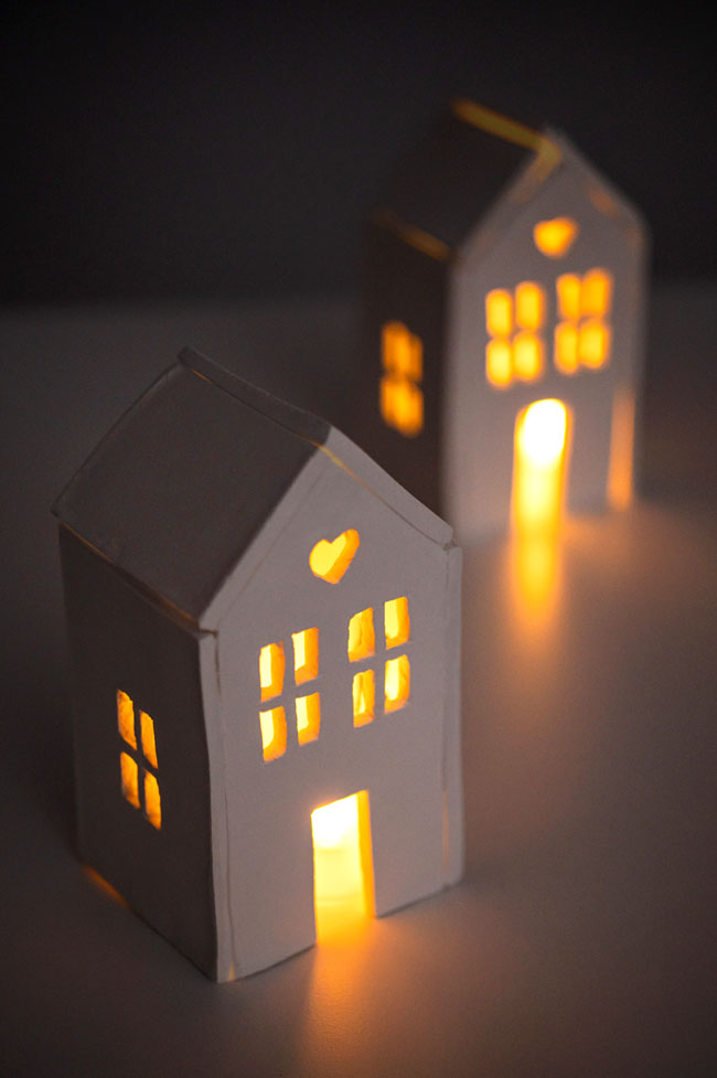 Two clay houses with tealights inside