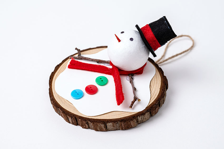Side view of a wood slice melted snowman craft
