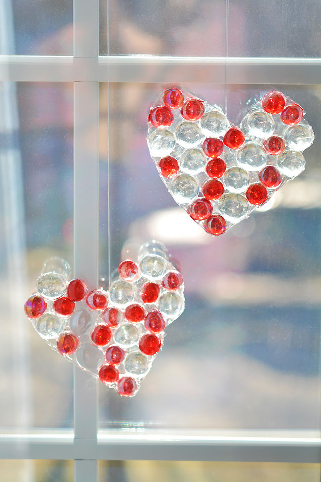 A pair of heart shaped glass bead suncatchers