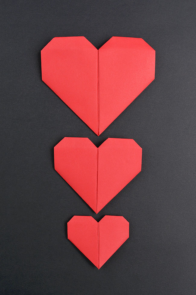 Red origami paper hearts in three different sizes