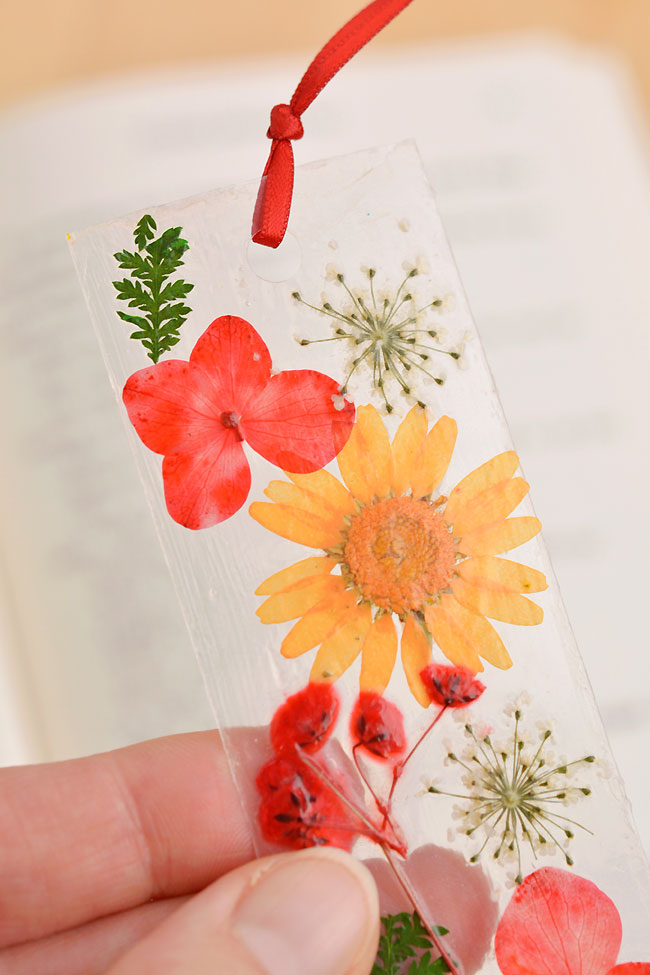 Closeup of a red and orange dried flower bookmark