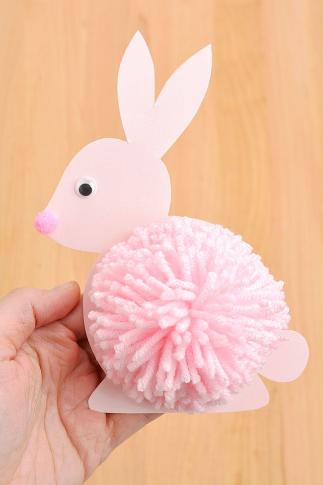 Pom pom bunny made with pink yarn and cardstock