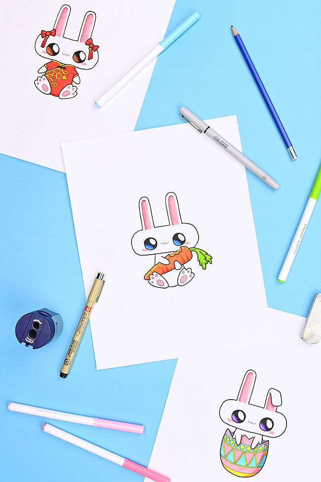 Bunny drawings surrounded by art supplies