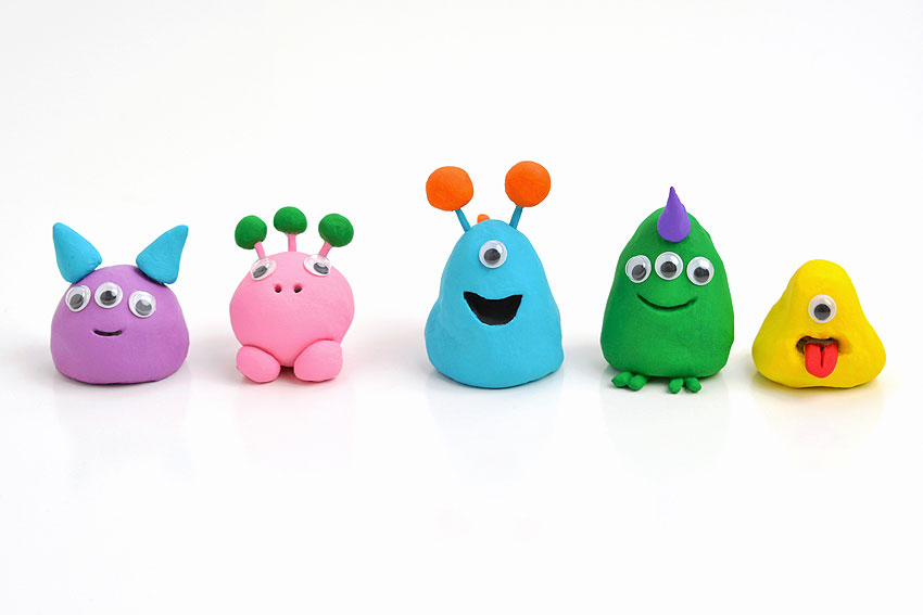 Group of fun clay monsters on a white background