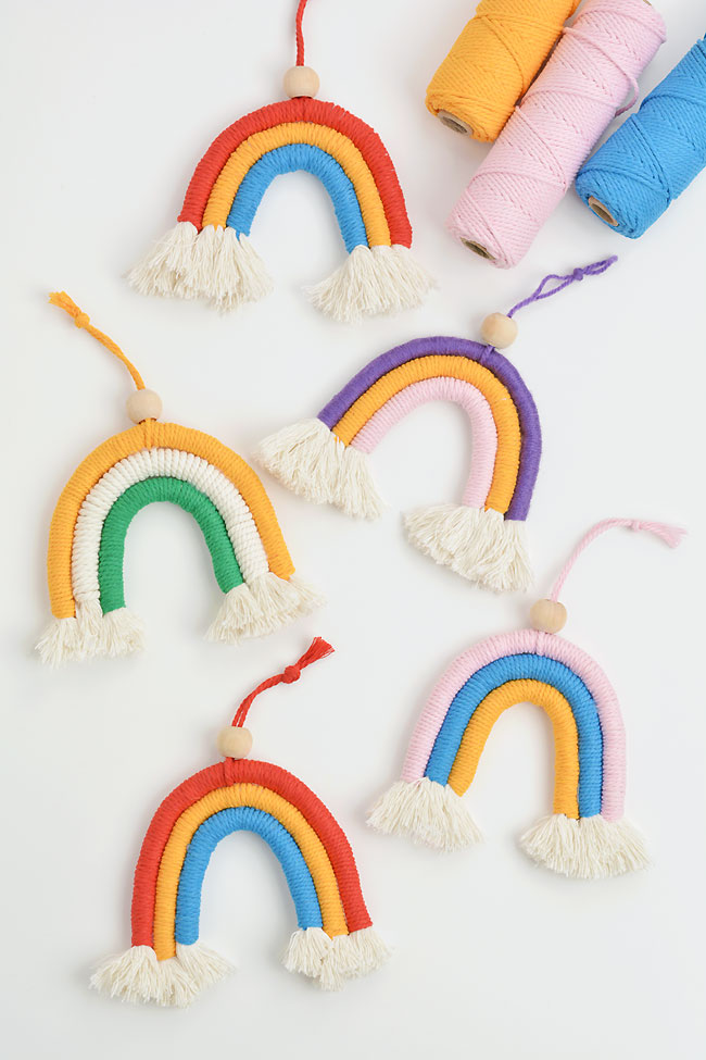 Group of colourful macrame rainbows on a white background