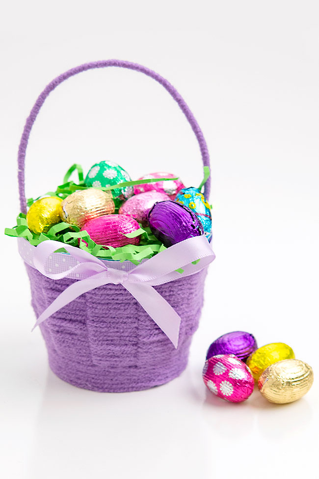 Small purple Easter basket filled with chocolate eggs