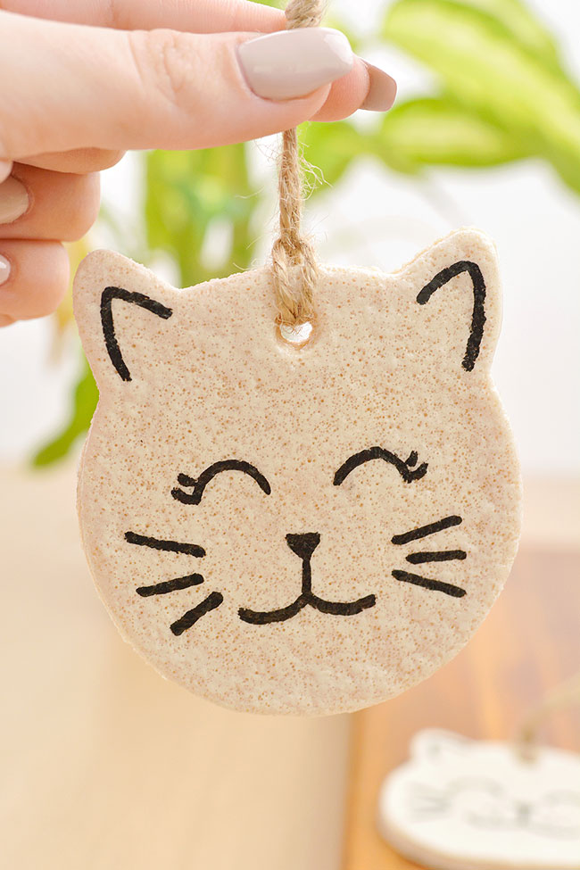 Dangling cat ornament held by the ornament hanger