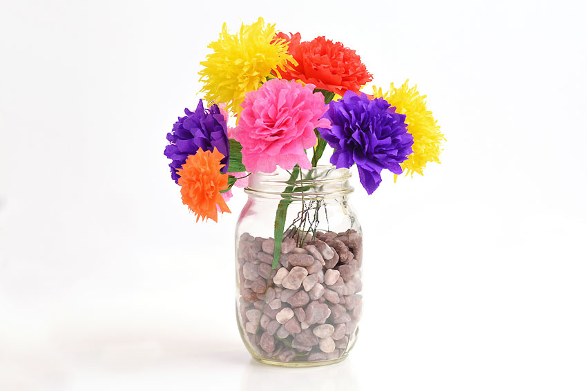 Colourful homemade crepe paper flowers in a vase