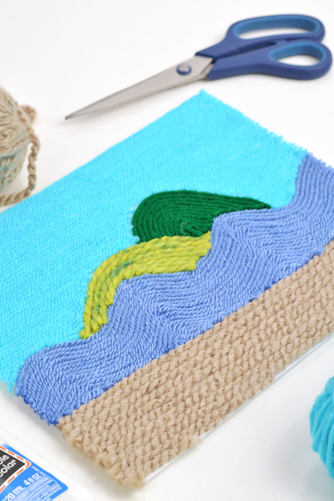 Yarn wall art of sand, water, and islands