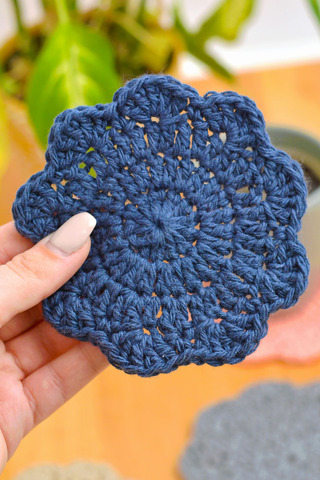 Closeup of a navy glue handmade crochet coaster