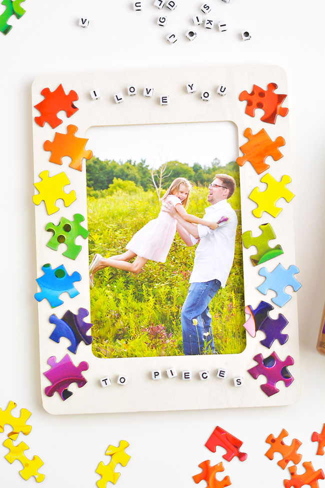 DIY picture frame craft decorated with puzzle pieces and letter beads