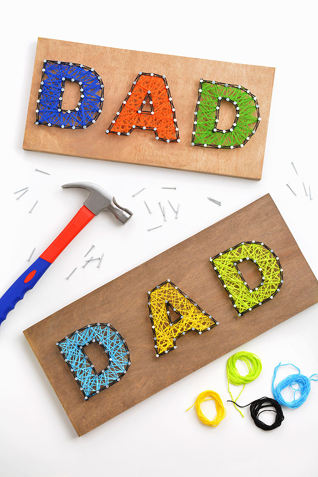 Dad string art patterns surrounded by a hammer, nails, and embroidery floss