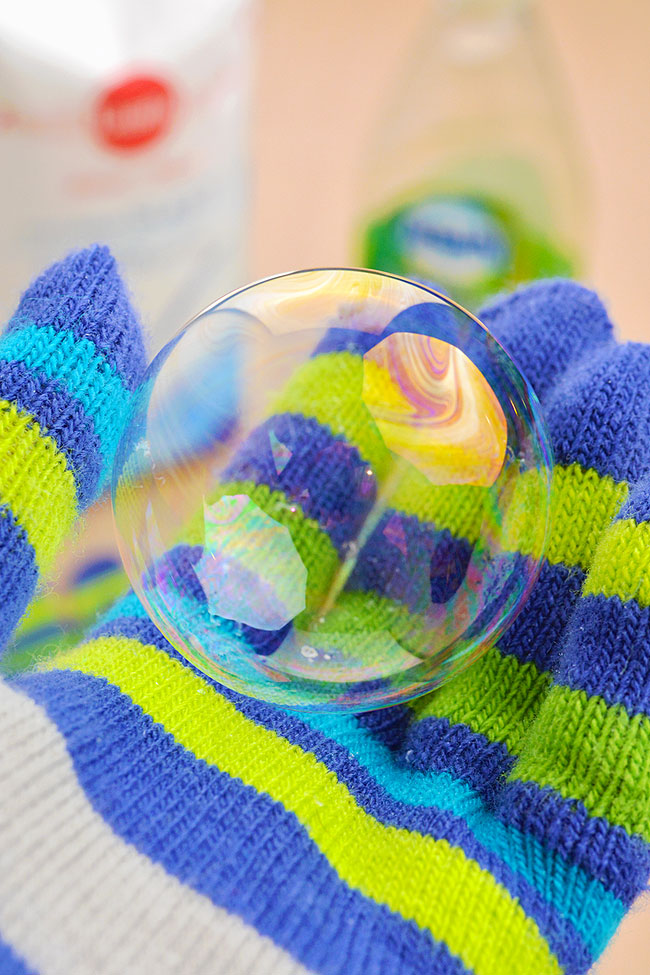 Holding a soap bubble made from a DIY bubble recipe