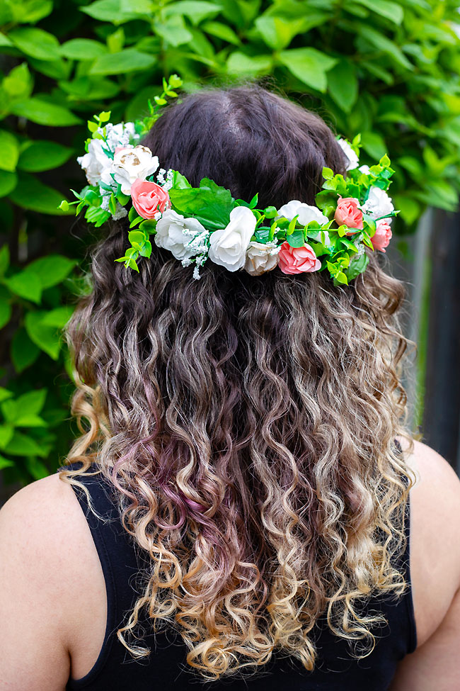 Flower crown on a head with curly brown hair