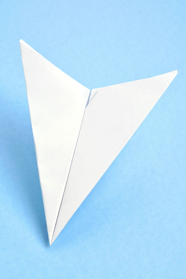 Printable paper airplane template folded into a paper plane