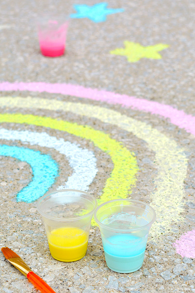 Painting a rainbow and stars with sidewalk chalk paint