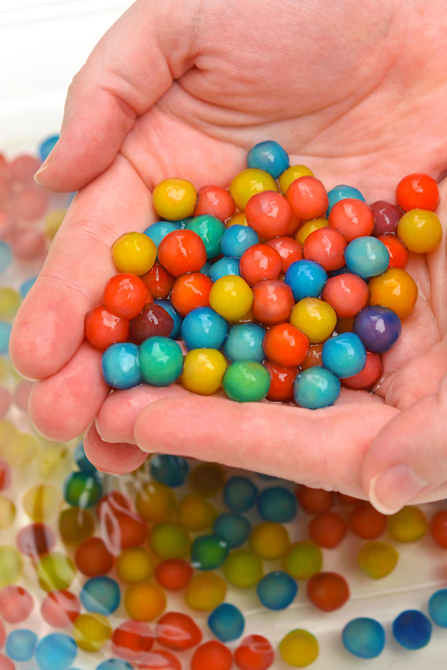 Holding a handful of edible water beads made with tapioca pearls