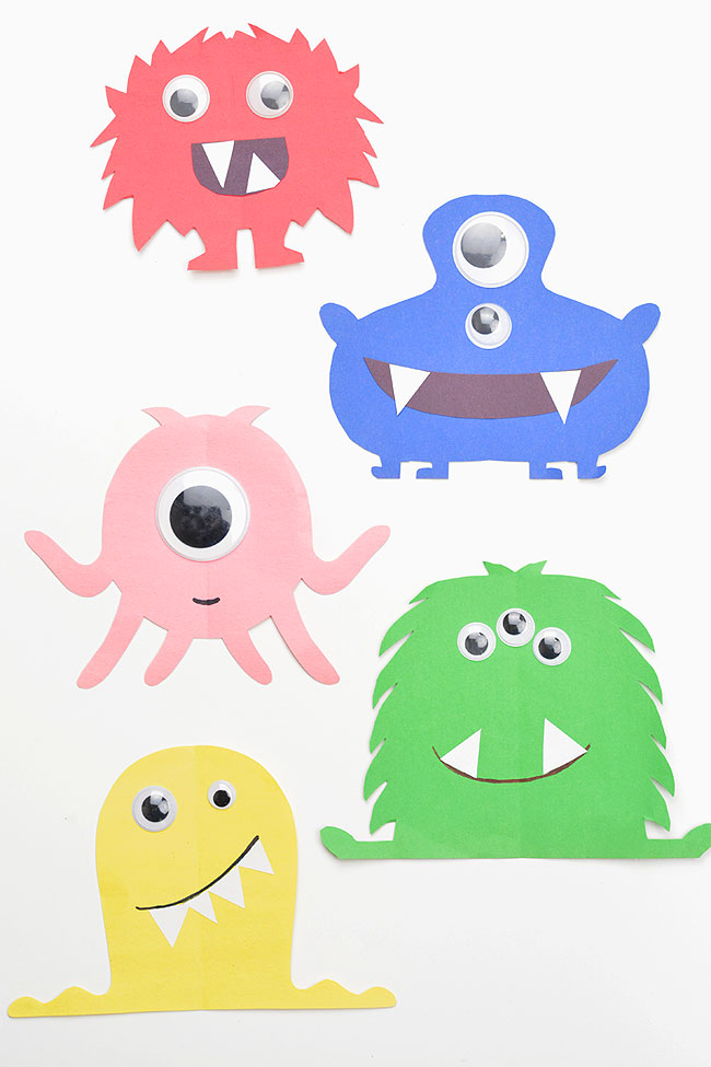 Colourful paper monsters on a white background