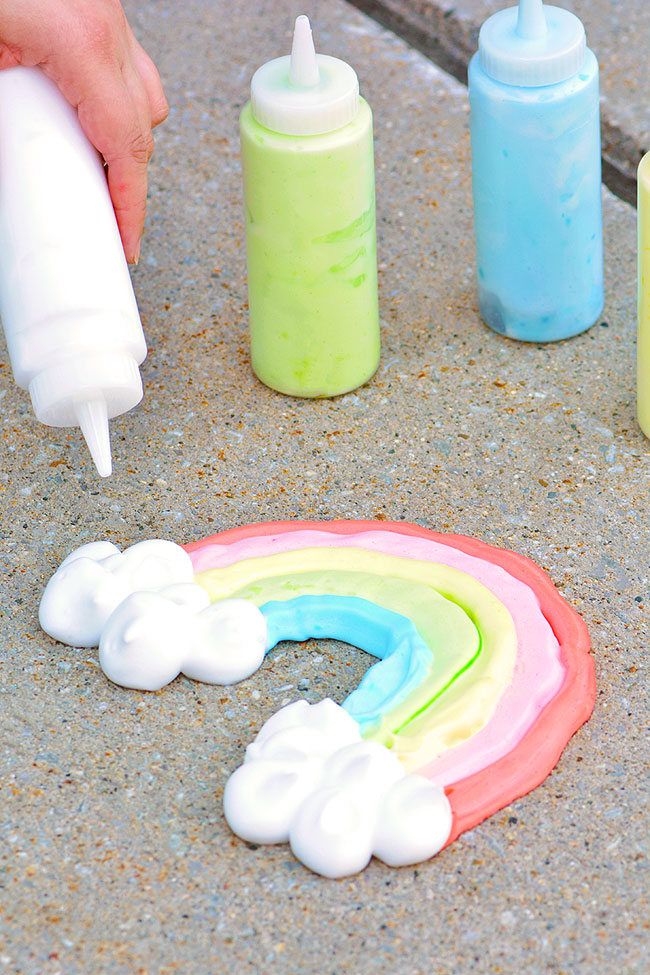 Painting a rainbow and fluffy clouds with puffy sidewalk paint