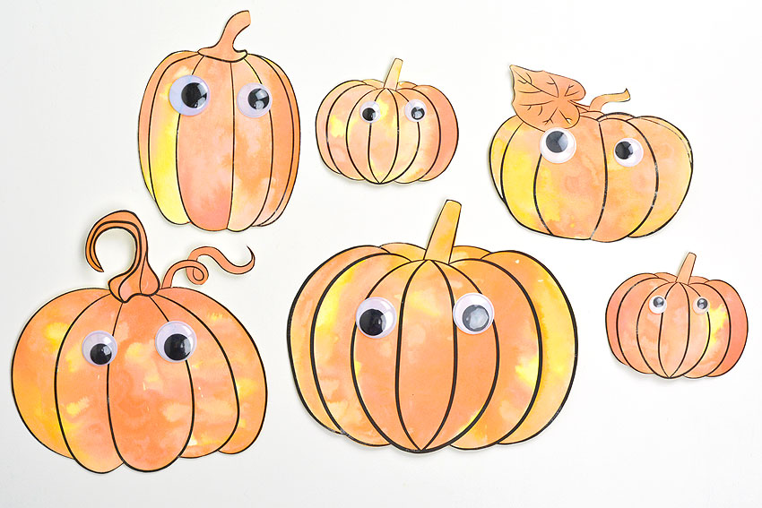 Six different pumpkins with googly eyes, painted with baking soda paint and vinegar
