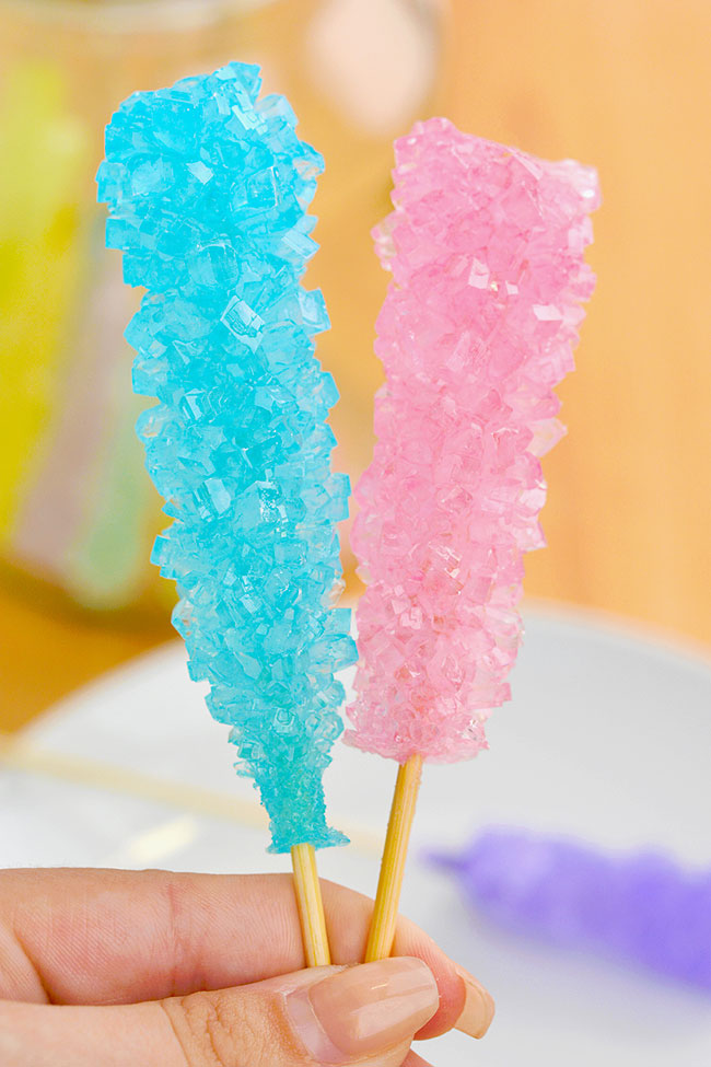 Large blue rock candy and pink sugar crystals from a DIY rock candy recipe