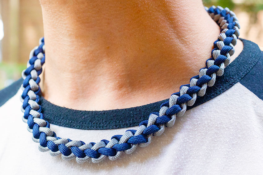 Wearing a paracord necklace in stylish navy and grey