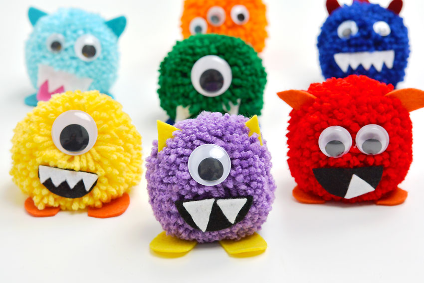 Group of cute and colourful monster pom poms