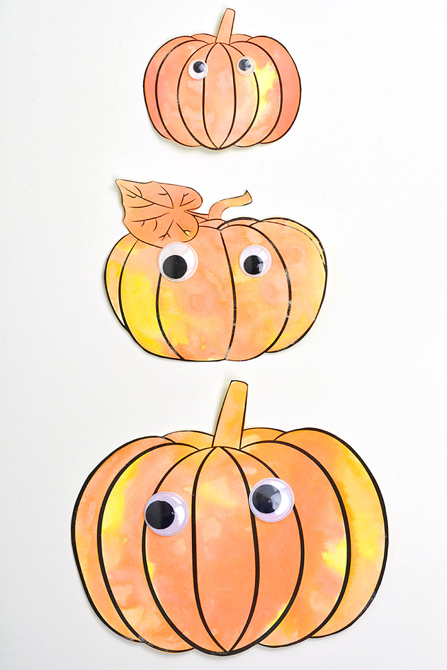 Three sizes of pumpkin templates painted with fizzy baking soda paint