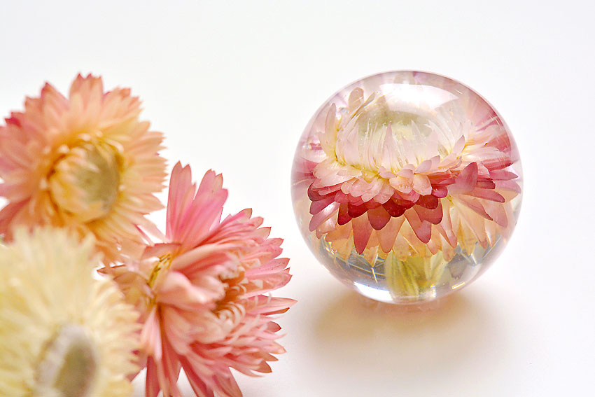 Dried flowers beside a flower preserved in epoxy resin