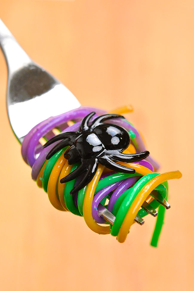 Halloween noodles twirled on a fork with a plastic spider