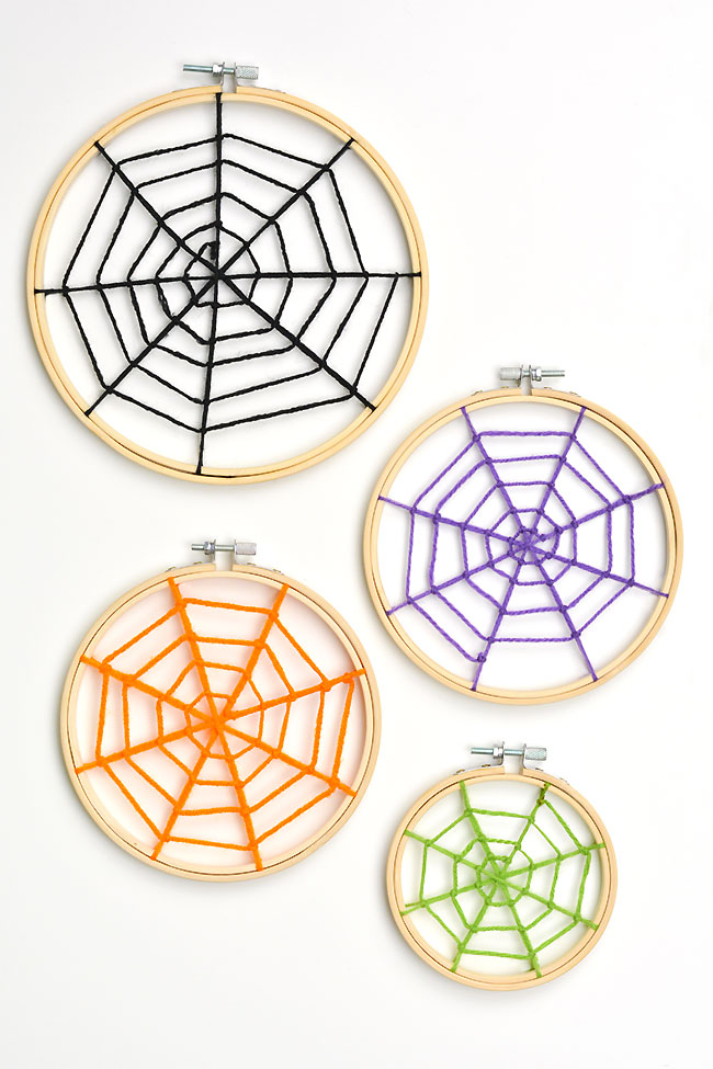 3 sizes of spider webs made from yarn on embroidery hoops