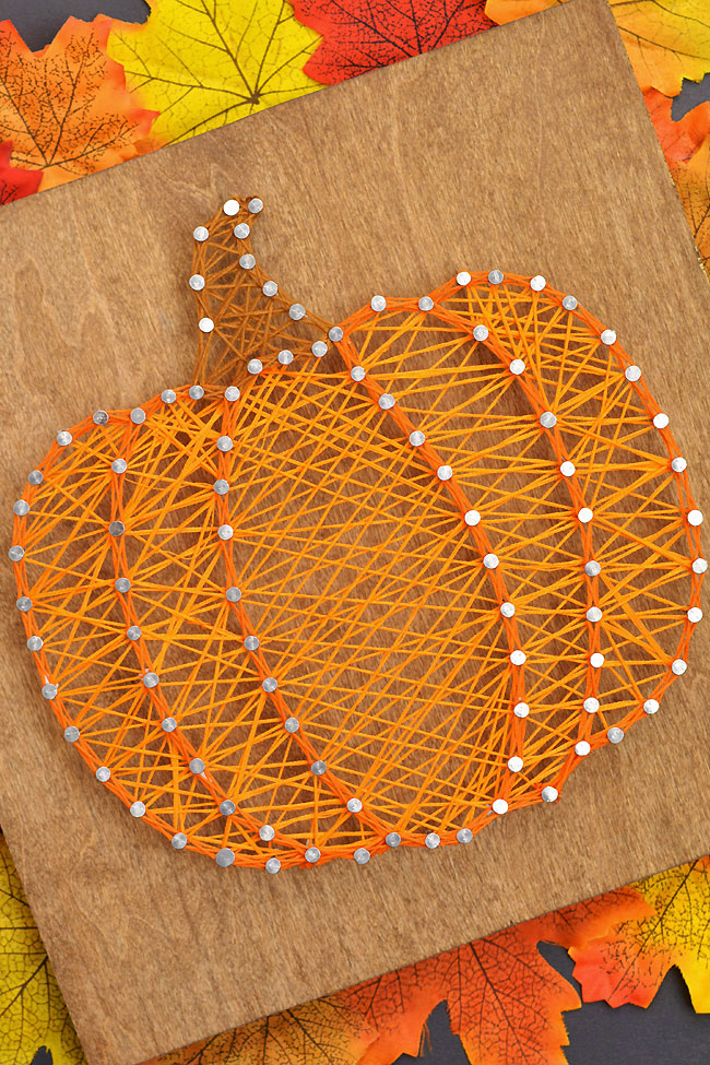 Pumpkin string art made with a free, printable template